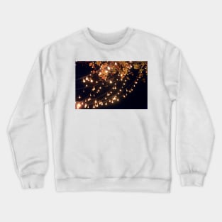 Lights draping off the Tree with a Black Sky in the background Crewneck Sweatshirt